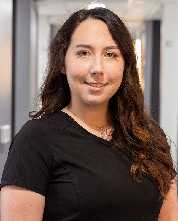 Professional portrait of a woman with long brown hair smiling at Hometown Dental office.